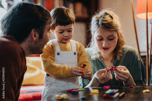 Family gathering for an enjoyable crafting activity, fostering creativity and bonding. Parents and child share a meaningful moment of joy and imagination in a cozy indoor setting.