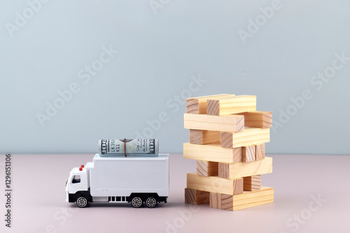 Fototapeta Naklejka Na Ścianę i Meble -  White toy truck with boxes on a light background, space for text.