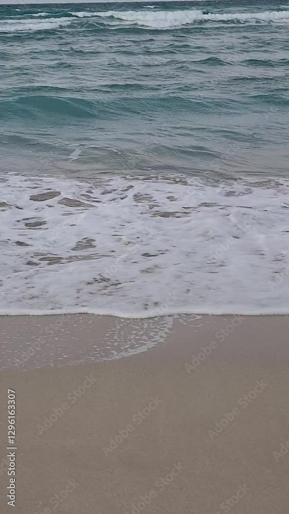 Waves crash on the sandy shores of Hamdeok Beach, Jeju Island Waves crash on the sandy shores of Hamdeok Beach, Jeju Island