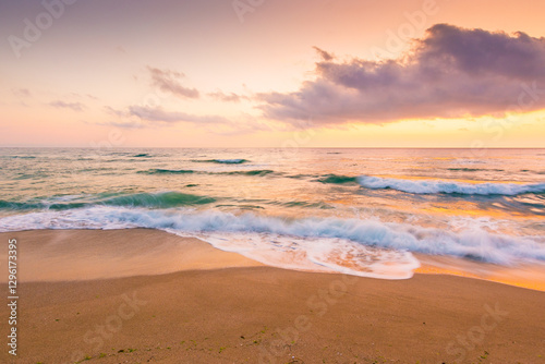 Obraz na płótnie summer vacation at the sea. outdoor adventure. beautiful purple pink seascape at sunrise. calm waves wash the golden sandy beach. fluffy clouds on the sky. inspiration wallpaper w salonie