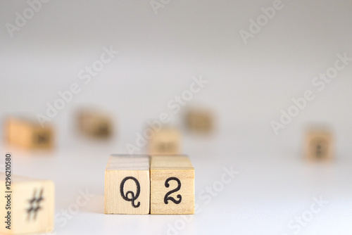 Second quarter acronym. word Q2 written on wooden cubes isolated on white background with copy space. Concept of Business Accounting, Automotive classification, Quarters