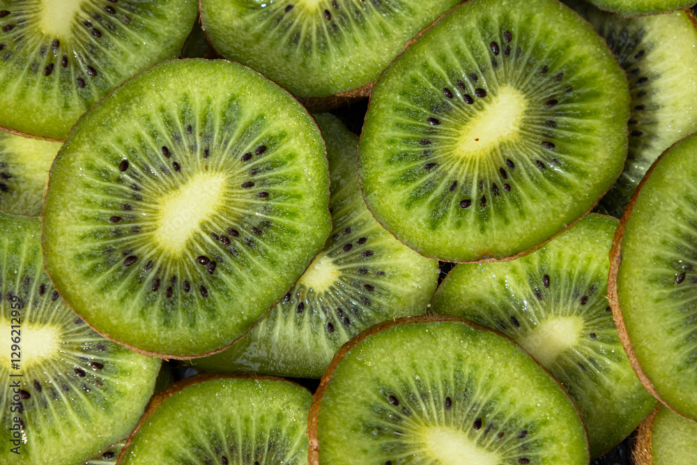Close up of fresh kiwis cut into slices. Greenish food with an ellipse shape covered with a skin full of hairs Close up of fresh kiwis cut into slices. Greenish food with an ellipse shape covered with a skin full of hairs