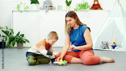 Baby Sign Language. Nonverbal child learning to sign with the help of a speech therapist. Child therapy, neurodiversity, learning difficulty, developmental disability.