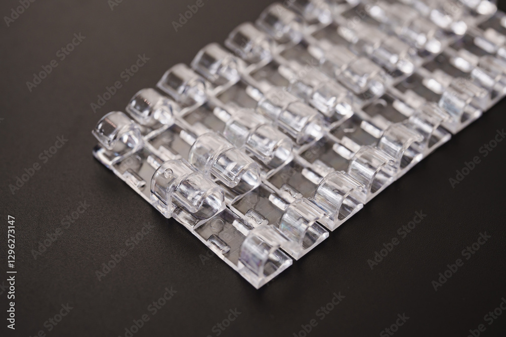 Lots of clear plastic wire holders on the black surface. details for a comfortable life and aesthetics. Lots of clear plastic wire holders on the black surface. details for a comfortable life and aesthetics.