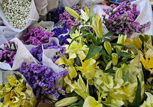 Photography Background from colorful bouquets for religious offerings on street vendor stall at Big flower market in Bangkok, Thailand