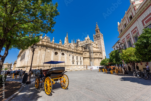 Obraz na płótnie Seville, Spain - August 01, 2024: Sevilla Cathedral (Catedral de Santa Maria de la Sede), Gothic style architecture in Spain, Andalusia. Historic buildings and monuments of Seville, Spain. w salonie