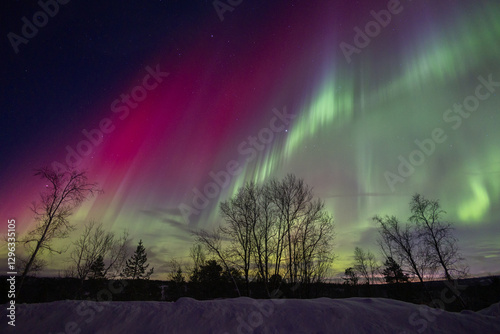 Wallpaper Mural A beautigul autora borealis display over the snowy Norvegian winter landscape. Northern lights in Norway sky. Arctic nature in Scandinavia during winter season. Torontodigital.ca