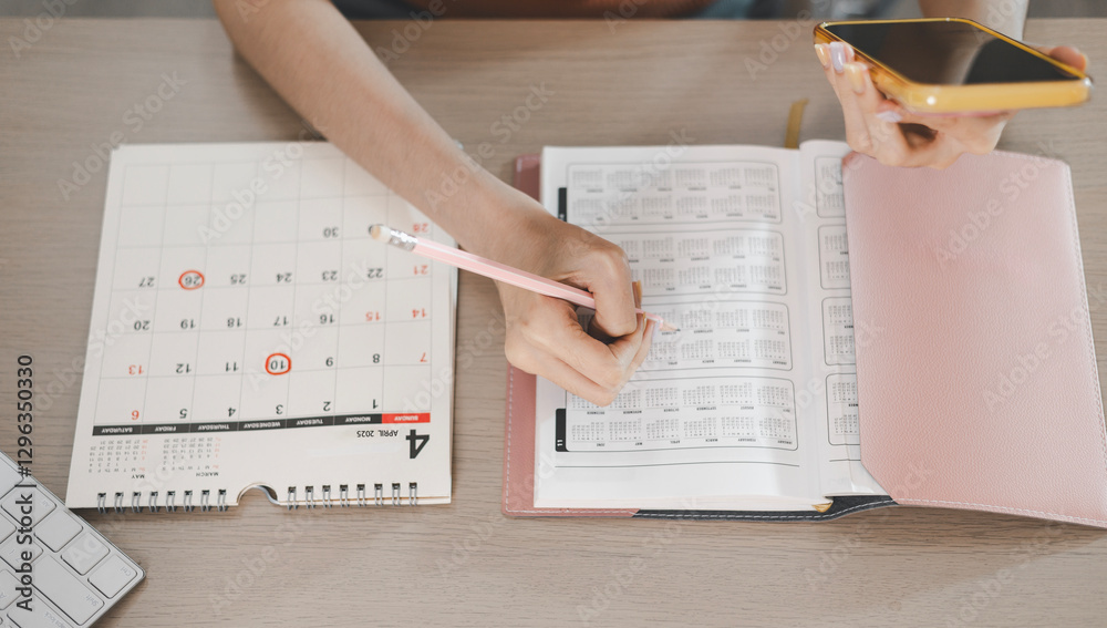 Obraz premium Planning and scheduling meeting calendars, events, time management, reminders and notifications about important events. Woman circling on work calendar.