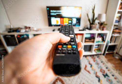 Hand with remote control. Streaming services and watching TV concept.