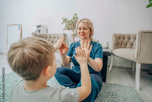 child and therapist learning sign language together on soft carpeted floor, natural light and relaxing atmosphere, concept of inclusive education and language learning