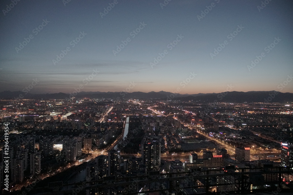 Fototapeta premium Evening Beijing city skyline with mountains in background
