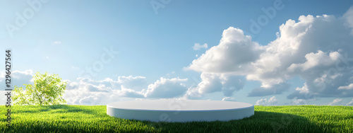 White, round podium on a green grass meadow with a blue sky background
