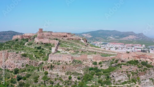 Drone moves away from an old ruined castle in the city of Sagunto, Spain