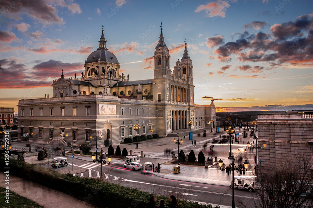 Obraz premium View of Almudena Cathedral in Madrid, Spain, at sunset with pink clouds and street lights on