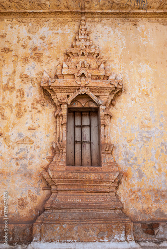 Weathered wall and window of a Laotian temple in Vientiane, Laos, Asia