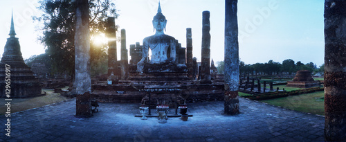 Panoramic view of statue of Buddha at sunset, Sukhothai Historical Park, Sukhothai, Thailand.