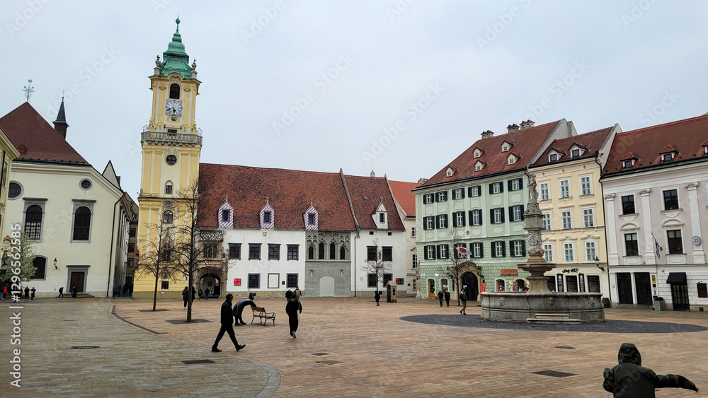 Obraz premium Scenic European Square with Historic Buildings and Clock Tower