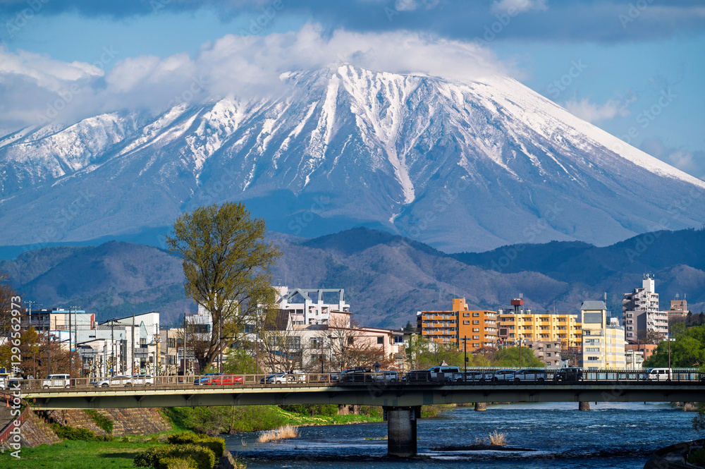 Buildings and promenade and riverside walkway at Katakami riverflowing through the middle of Morioka city, Iwate Cityscape with Iwate Mount Background scene in Morioka, Iwate, Japan