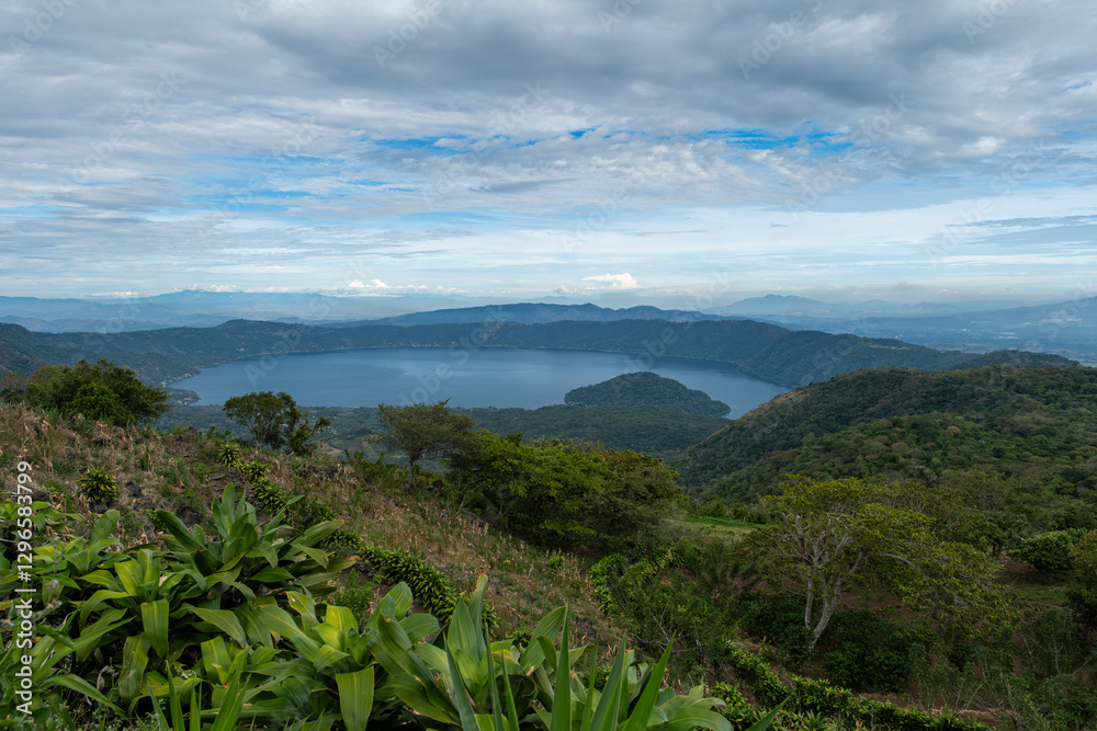 Fototapeta premium Wide angle panoramic aerial view of Lake Coatepeque with Teopan Island - inactive volcano crater lagoon in western mountain region of El Salvador near Santa Ana city. 