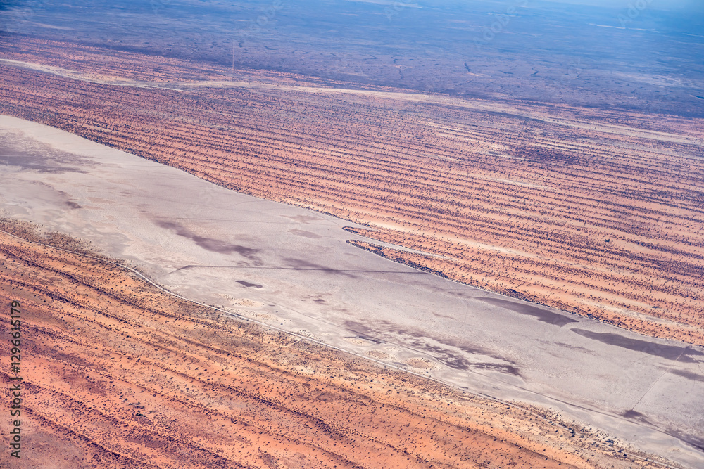 pan among stripes of red dunes in Kalahari desert countryside, near Intu Afrika lodge, Namibia