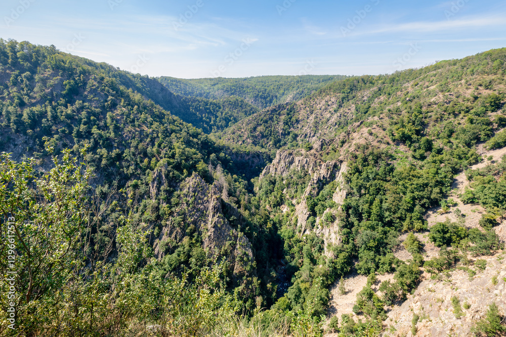 Fototapeta premium The 403-metre-high granite crag Rosstrappe in the Harz Mountains in Germany is a popular viewpoint and can be reached by foot or chair lift. It offers views of the Witch Dance Square and Bode Valley.