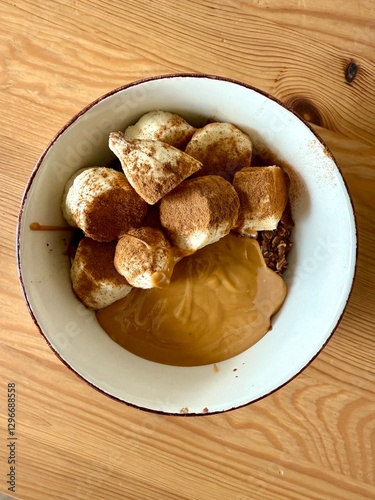 Banana slices with cinnamon powder, peanut butter on porridge