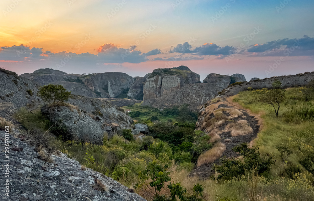 Breathtaking sunset over the Pedras Negras Mountains in Angola showcasing rugged terrain and lush valleys