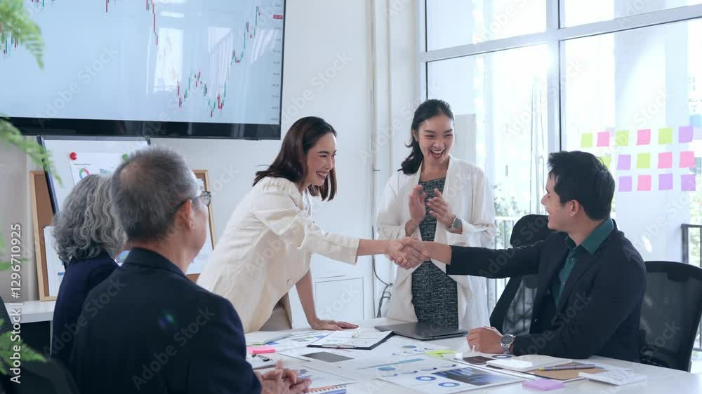 Business professionals congratulating each other with firm handshake, clapping hands, expressing teamwork success in contemporary corporate workspace, signaling mutual accomplishment Business professionals congratulating each other with firm handshake, clapping hands, expressing teamwork success in contemporary corporate workspace, signaling mutual accomplishment