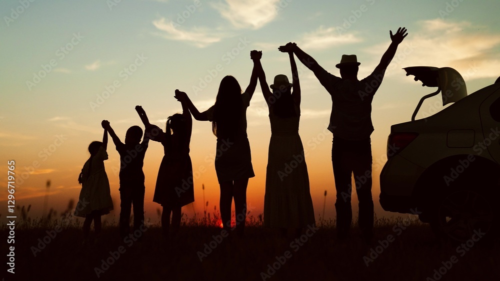 Happy family, silhouettes at sunset. Big family kids childs siblings parents holding hands appreciating enjoying orange setting sun together by car. Closeness family bonds joint recreation at nature Happy family, silhouettes at sunset. Big family kids childs siblings parents holding hands appreciating enjoying orange setting sun together by car. Closeness family bonds joint recreation at nature