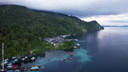 The karst cliffs of Negeri Sawai in Maluku are majestic limestone formations that rise by the sea, surrounded by green forests and clear water.