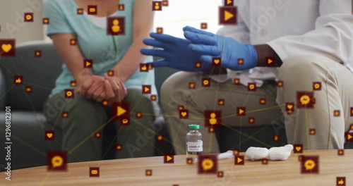 Wallpaper Mural Image of network of connections with icons over diverse doctor talking with patient Torontodigital.ca