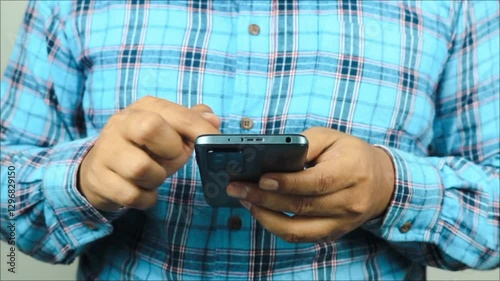 Cropped man holding smartphone expressing excitement photo