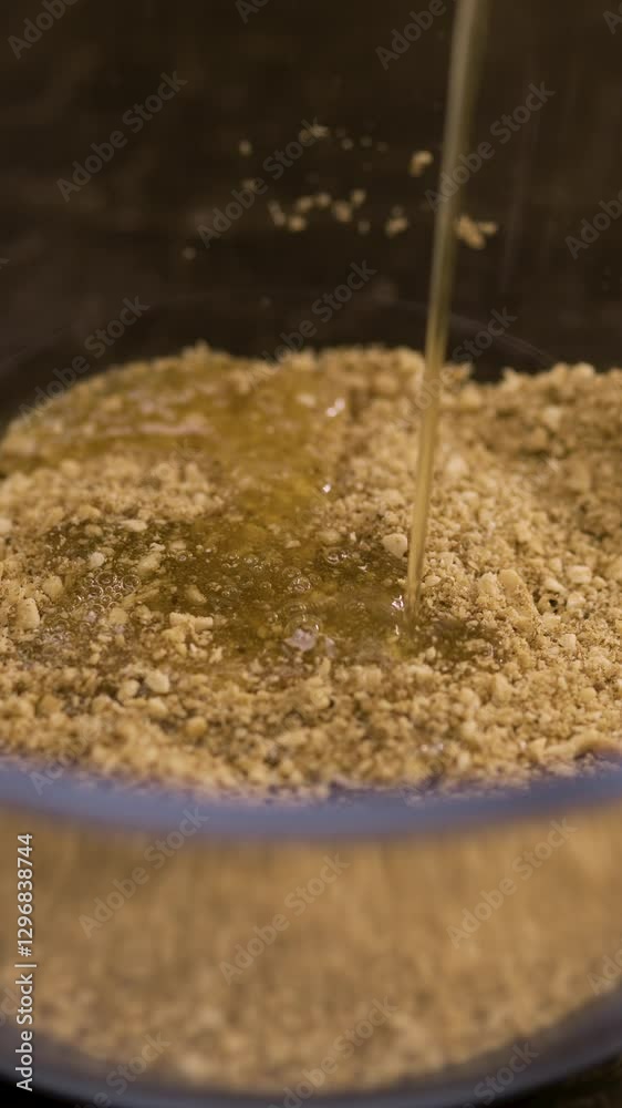 Chopped Nuts and honey. Honey pouring on walnuts in bowl, close-up. Healthy food Chopped Nuts and honey. Honey pouring on walnuts in bowl, close-up. Healthy food