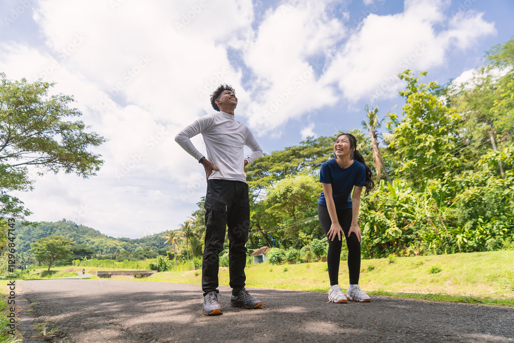 active asian young couple take a break from exercise at rural area active asian young couple take a break from exercise at rural area