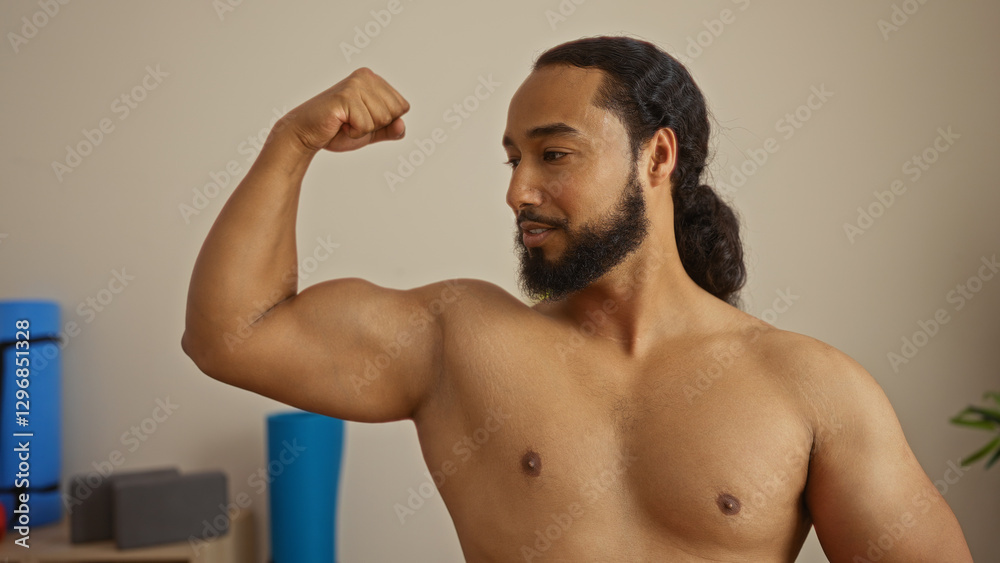 Man flexing muscles in a wellness center with fitness equipment around, illustrating strength and relaxation in a serene spa environment. Man flexing muscles in a wellness center with fitness equipment around, illustrating strength and relaxation in a serene spa environment.