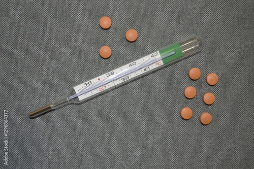 thermometer and colored tablets