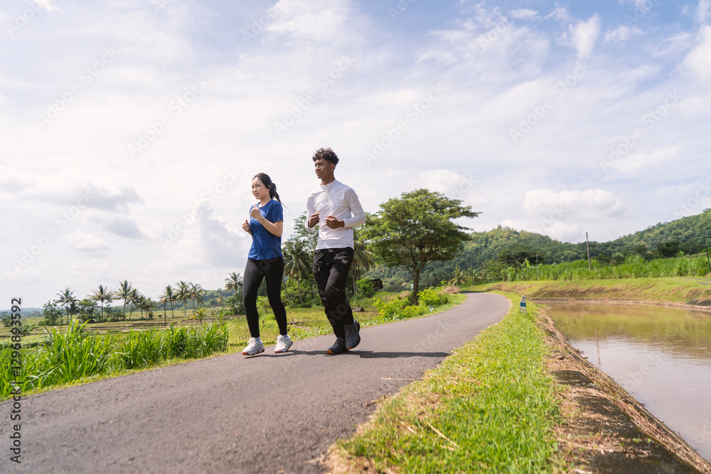 active asian young couple jogging and running exercise at rural area active asian young couple jogging and running exercise at rural area
