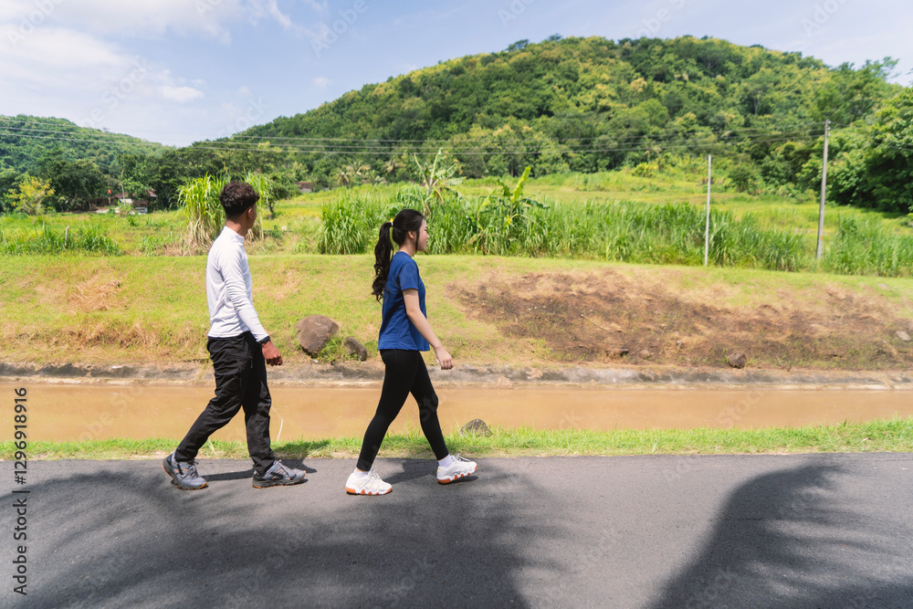Fototapeta premium active young asian couple walking exercise at rural area