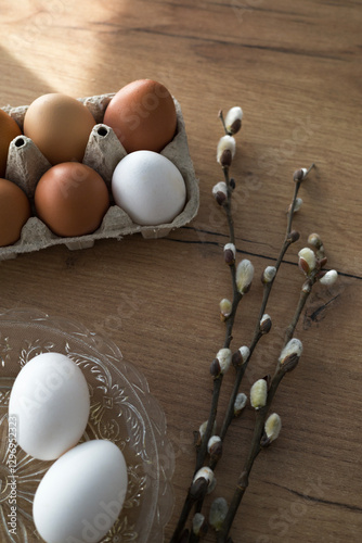 Fresh farm eggs in carton box on wooden table. Eggs in egg boxes