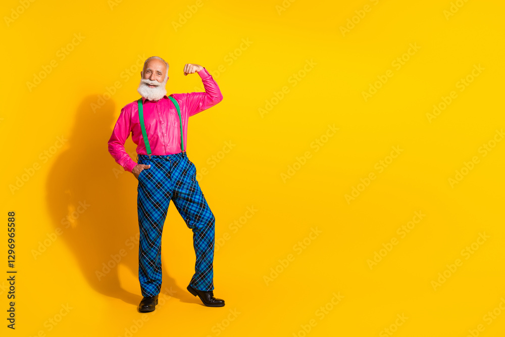Fototapeta premium Full size photo of handsome pensioner mister flexing muscles wear pink shirt retro plaid pants classy garment isolated on yellow background