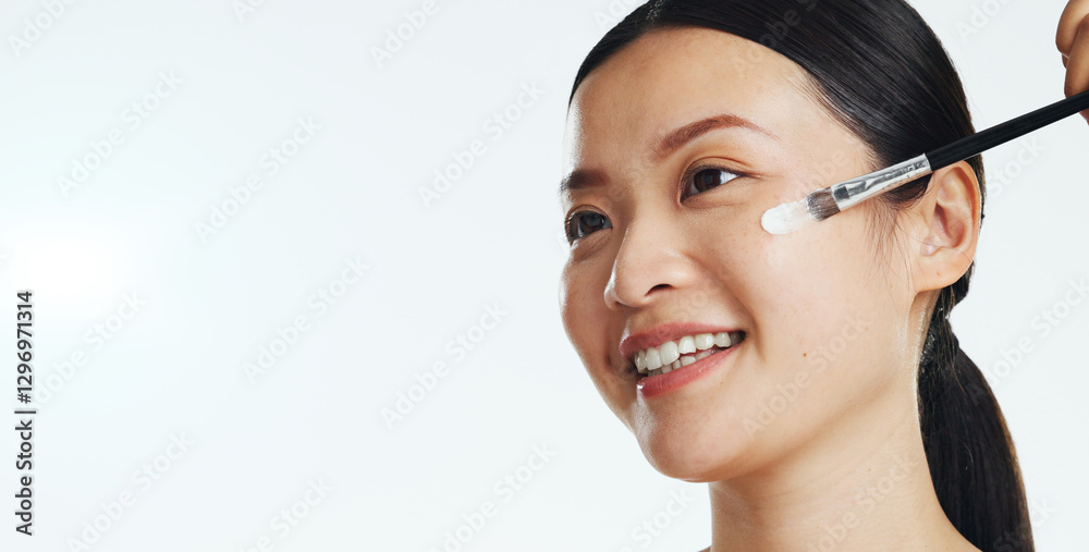 Asian woman, face and brush cream for beauty, aesthetic skincare and mockup white background. Happy studio model, makeup and facial lotion for dermatology, collagen cosmetics and smile of happiness Asian woman, face and brush cream for beauty, aesthetic skincare and mockup white background. Happy studio model, makeup and facial lotion for dermatology, collagen cosmetics and smile of happiness