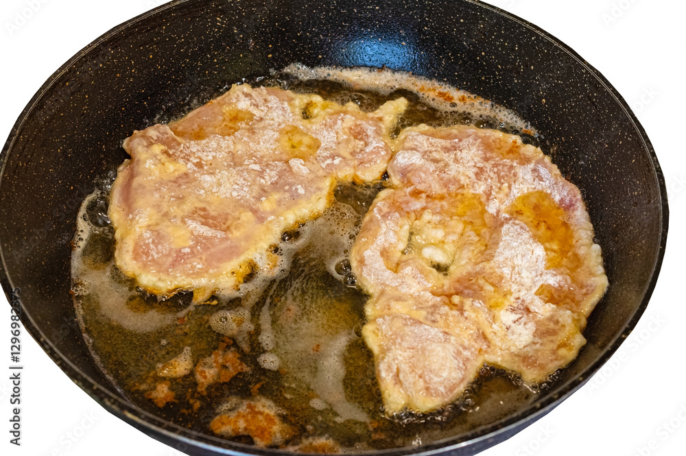 The cooking process in a pan of fried chop in batter. The cooking process in a pan of fried chop in batter.