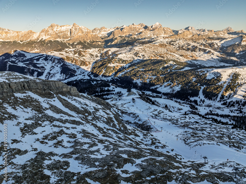 Fototapeta premium Italian Dolomites drone aerial view in winter snow ski sunny days. Sella Ronda Marmolada .Aerial landscape of snowy Italian Alps Dolomites with Sella group in front and Marmolada. Sella Ronda group.