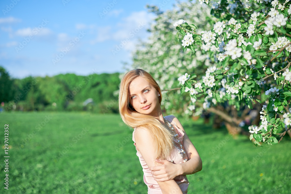 A woman stands in a field of flowers on a sunny spring day, wearing a pink dress. She looks happy and contented as she poses for the camera. The scene is peaceful and serene. A woman stands in a field of flowers on a sunny spring day, wearing a pink dress. She looks happy and contented as she poses for the camera. The scene is peaceful and serene.