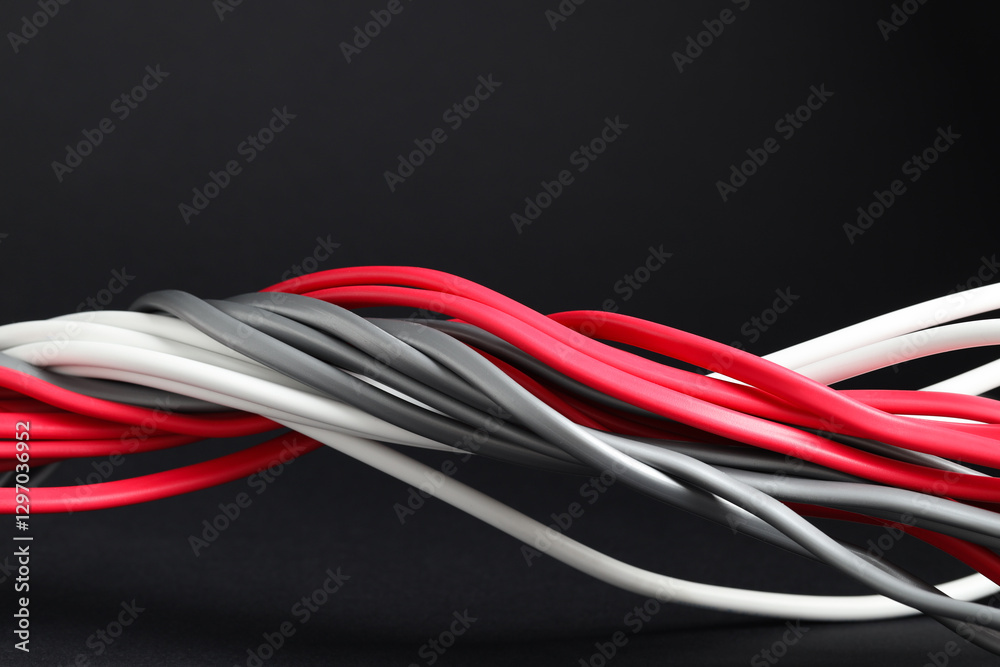 Many electrical wires on black background, closeup Many electrical wires on black background, closeup