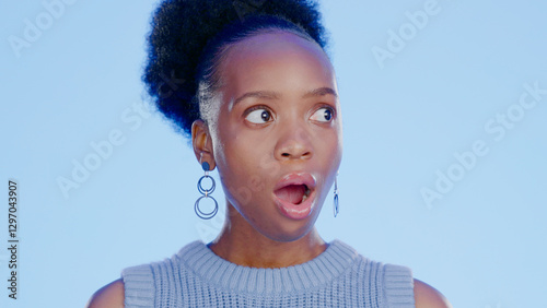 Black woman, open mouth with shock or surprise, drama or secret news with gossip isolated on blue background. Wow reaction to information, expression of alarm and alert with announcement in studio