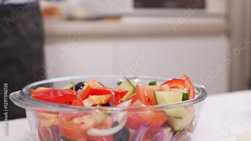 Wallpaper Mural Woman mixing ingredients for Greek salad in glass bowl in kitchen. Close up. Torontodigital.ca