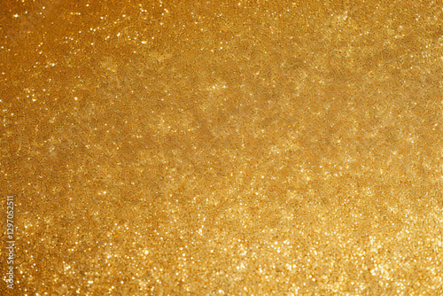 Abstract background of gold sparkling glitter material.