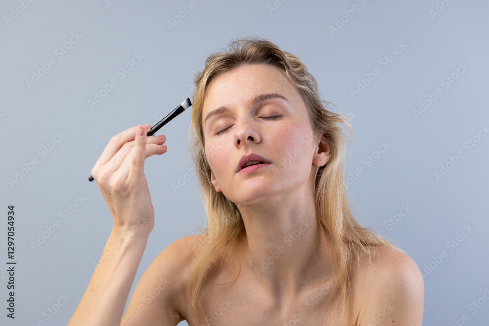 Exploring the Art of Makeup: A Woman Applying Makeup with Precision and Care to Enhance Her Natural Beauty and Confidence in a Minimalist Setting Exploring the Art of Makeup: A Woman Applying Makeup with Precision and Care to Enhance Her Natural Beauty and Confidence in a Minimalist Setting