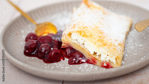 Pancakes, thin pancakes on a plate with cherries and cheese.